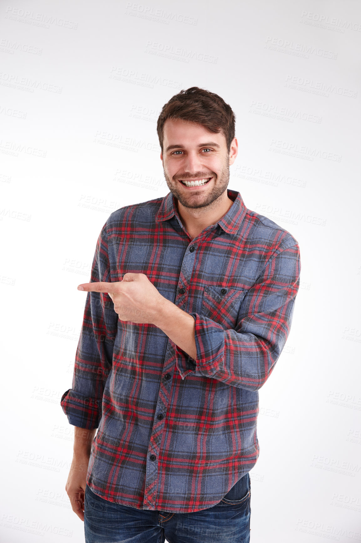 Buy stock photo Studio portrait of a smiling young man pointing at copyspace to the left