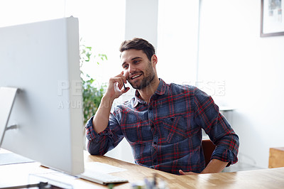 Buy stock photo Shot of a casual young designer talking on his phone in his office