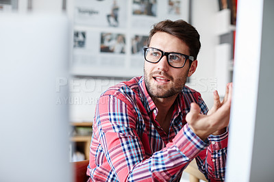 Buy stock photo Shot of a young designer explaining something to a colleague