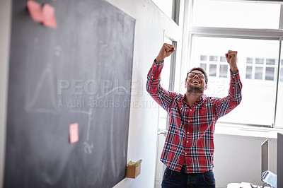 Buy stock photo Shot of an ecstatic young designer raising his fists in victory