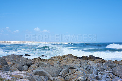 Buy stock photo Ocean, waves and rocks on coast of beach in Malaysia for outdoor travel in summer for vacation or holiday. Sea, stone and blue sky with landscape for wallpaper or background, water and nature.