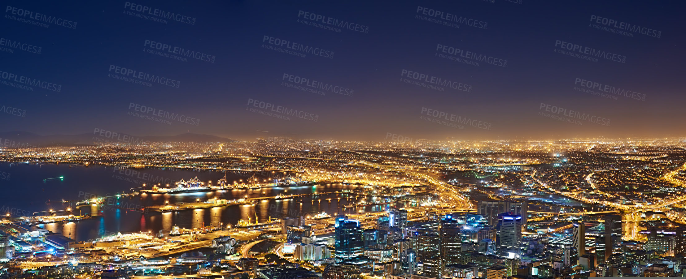 Buy stock photo Lights, buildings and drone of the city at night with urban development, sea water and streets. Dark, travel and aerial view of outdoor residential architecture of downtown with a harbour in evening.