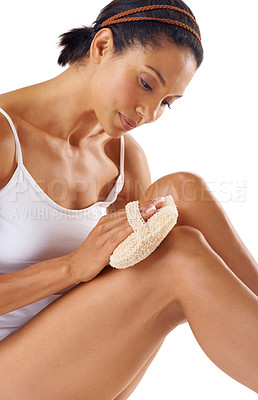 Buy stock photo Body care, wellness and model doing exfoliation on her legs in studio for self care, clean and natural routine. Cosmetic, health and woman from Brazil scrub her body for skincare by white background.