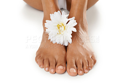Buy stock photo Feet, flower and natural skincare for pedicure, spa or relaxation against a white studio background. Isolated barefoot of toes with white floral petals for healthy treatment, body care or skin care