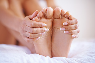 Buy stock photo Feet, beauty spa and pedicure or manicure on nails of a woman on home bed for luxury skincare. Toes and hands of wellness model for self care, cleaning and dermatology cosmetics to relax and massage