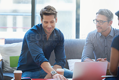 Buy stock photo Shot of a group of office workers talking together in a meeting room