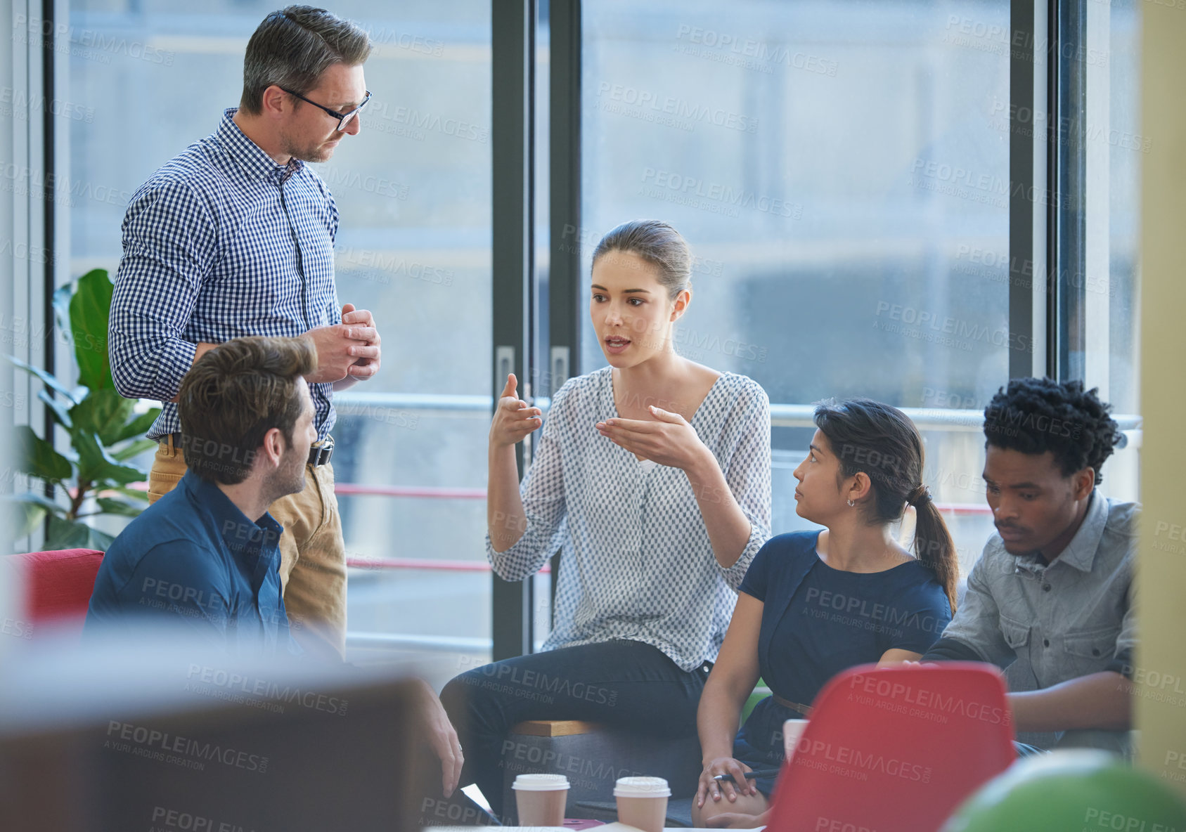 Buy stock photo Shot of a group of office workers talking together in a meeting room