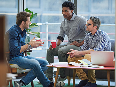 Buy stock photo Shot of a group of office workers talking together in a meeting room