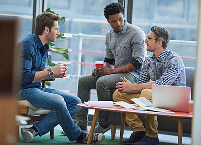 Buy stock photo Shot of a group of office workers talking together in a meeting room