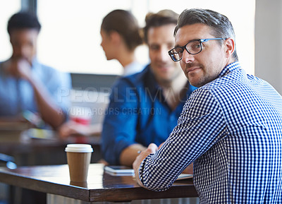 Buy stock photo Portrait of a two colleagues having a talk over coffee in an office