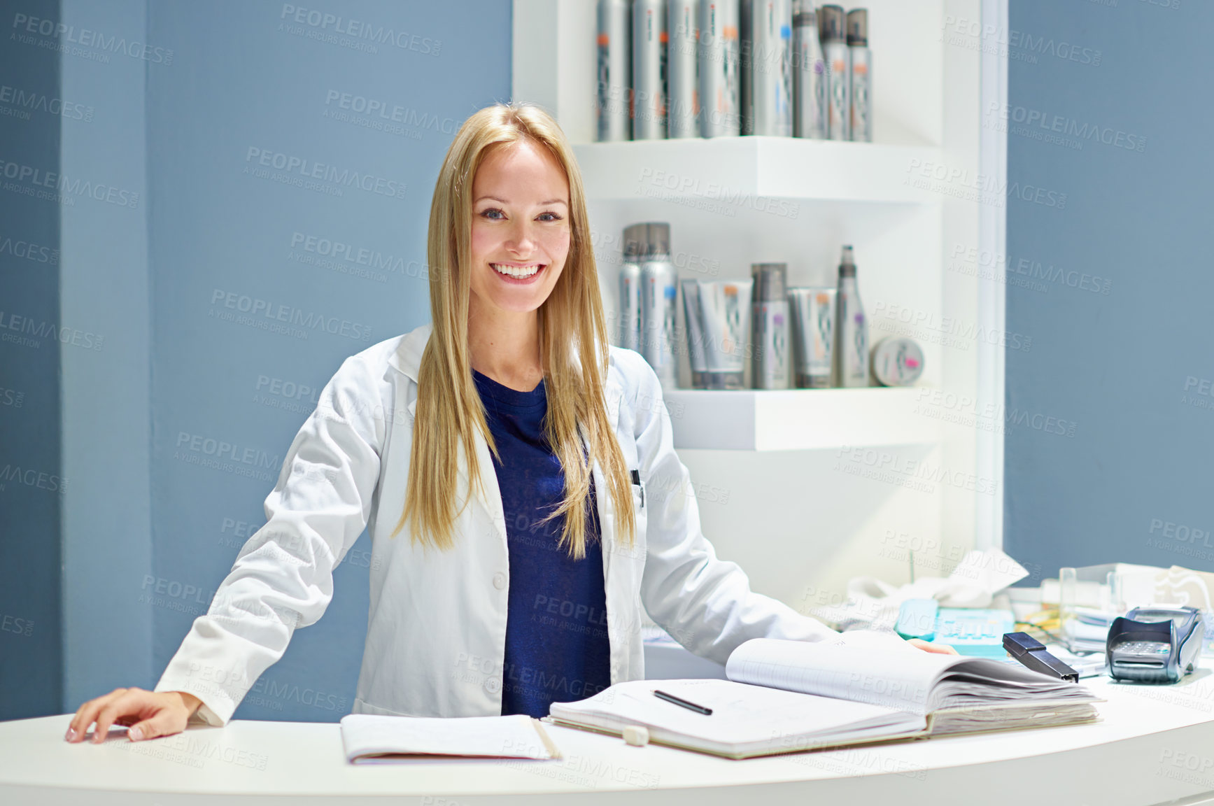 Buy stock photo Portrait of an attractive young woman at the counter of a cosmetics store