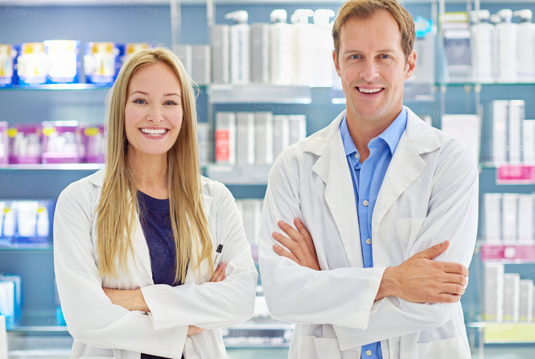 Buy stock photo Shot of two clinicians standing at the counter of a cosmetics store