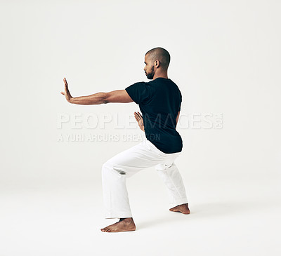Buy stock photo Man, studio and martial arts for defense practice, action and karate exercise on white background. Black male person, mockup space and training for combat, fight and position of attack in taekwondo
