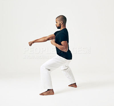 Buy stock photo Studio shot of a young martial artist practicing 