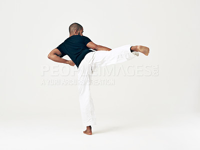 Buy stock photo Man, studio and martial arts for kick practice, action and karate exercise on white background. Black male person, mockup space and training for combat, back and position of attack in taekwondo
