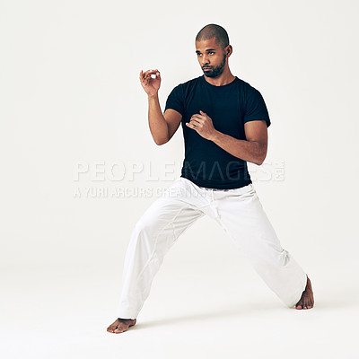 Buy stock photo Man, studio and ready for attack on martial arts, action and karate exercise on white background. Black male person, mockup space and training for combat, fight and position of fitness in taekwondo
