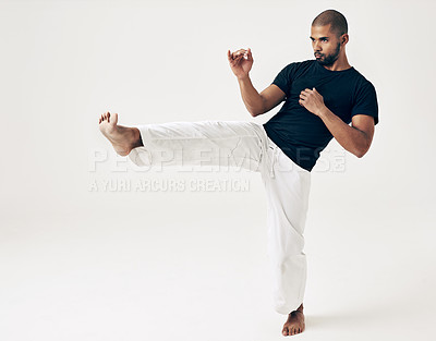 Buy stock photo Man, studio and karate for kick practice, action and martial arts on white background. Black male person, mockup space and training for combat, fight and position of attack in taekwondo for fitness