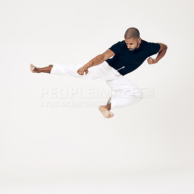 Buy stock photo Studio shot of a young martial artist practicing 