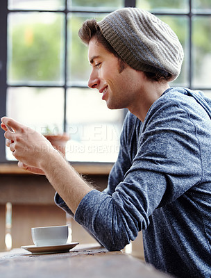 Buy stock photo Coffee shop restaurant, cellphone and happy man reading, texting or check email, phone notification or social network. Diner, morning wellness or person smile, happiness and typing blog on smartphone