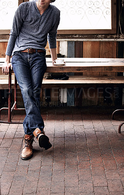 Buy stock photo Man, espresso and fashion for relaxing in coffee shop, denim and confident at cafe for casual outfit. Shirt, jeans and trendy male person with hot beverage for break, drink and leaning on table 