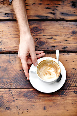 Buy stock photo Restaurant coffee cup, table and hands of person with beverage, caffeine latte or drink for morning stress relief. Wooden surface, top view and customer on espresso break in cafe, cafeteria or diner