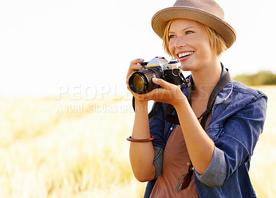 Buy stock photo Field, photographer and woman with a camera, adventure and thinking with ideas, nature and memory. Person, countryside and girl with photography, tourism and journey with sunshine, smile and travel