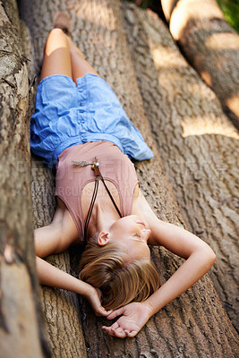 Buy stock photo Woman, tree trunk and relax or sleep in nature environment for forest wellness or vacation, travel or nap. Female person, resting and woods in New Zealand countryside for summer, trip or sustainable