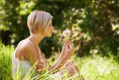 Buy stock photo Dandelion, outdoor and woman with nature, relax and summer with hope, forest and vacation with ideas. Person, park and girl with sunshine, woods and holiday with travelling, sitting and spring