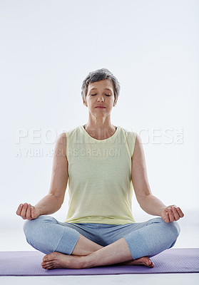 Buy stock photo Full length shot of an attractive woman meditating while doing yoga