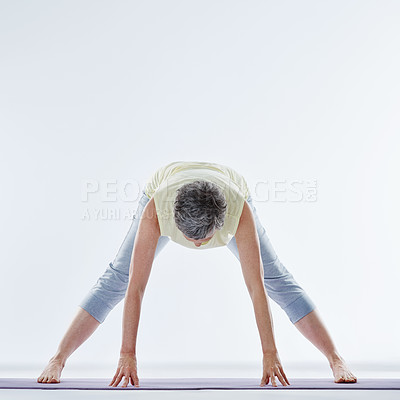 Buy stock photo Full length shot of a woman stretching before yoga