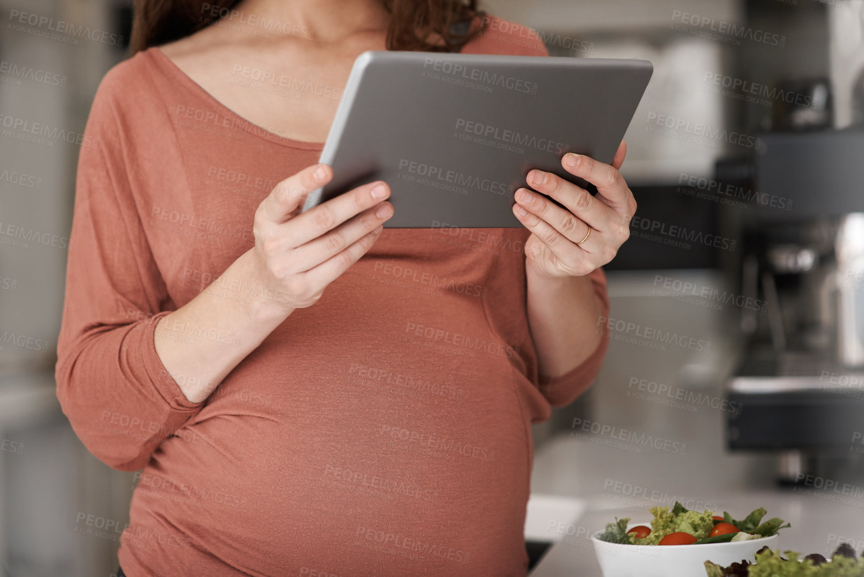 Buy stock photo Tablet, pregnancy and hands of woman in kitchen at home for healthy, wellness and diet recipe. Digital technology, prenatal care and pregnant female person reading maternity blog for food research.