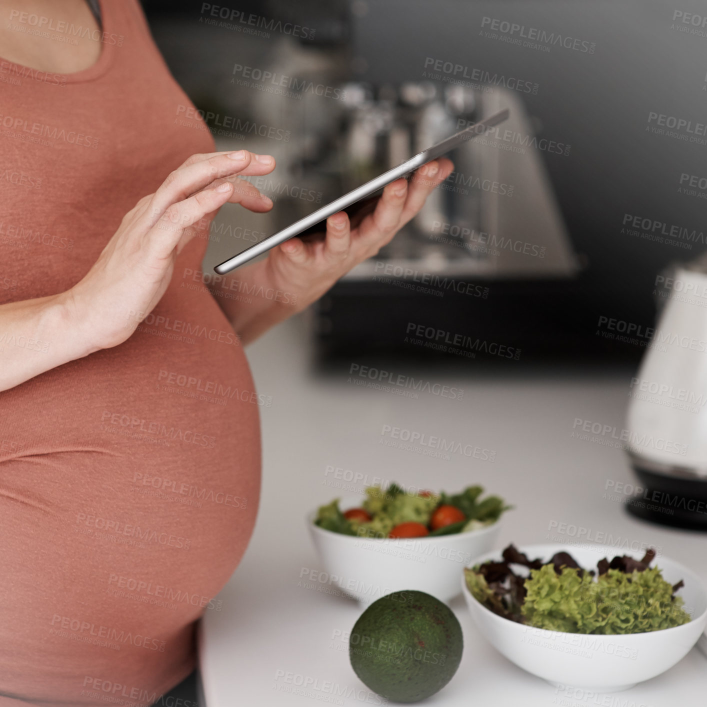 Buy stock photo Tablet, pregnancy and woman in kitchen with salad at home for healthy, wellness and diet recipe. Digital technology, prenatal care and pregnant female person reading maternity blog for food research.