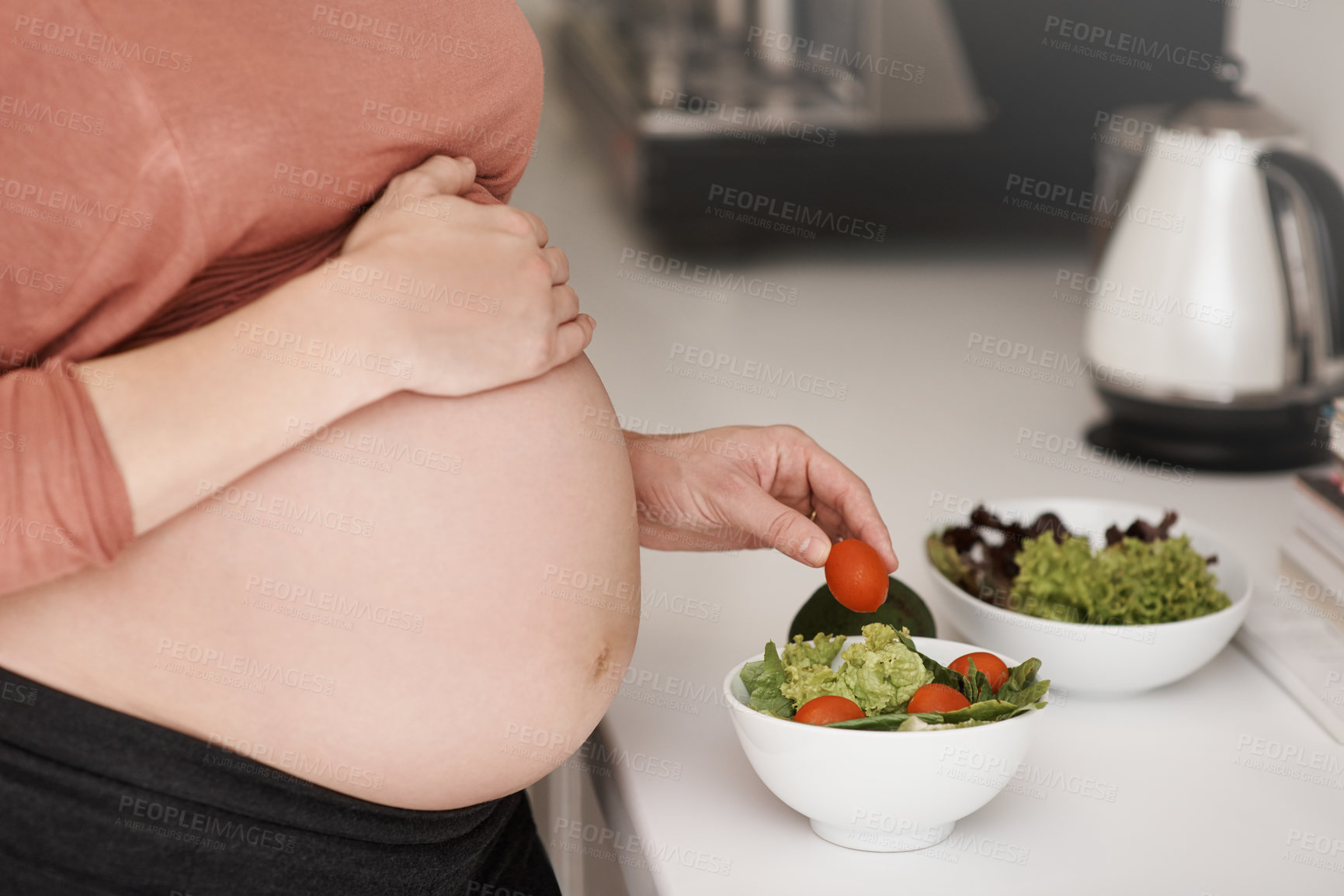 Buy stock photo Salad, pregnancy and woman with belly in kitchen for food with healthy, wellness and nutrition diet. Vegetables, vitamins and pregnant mother with fresh meal for lunch for prenatal care at home.