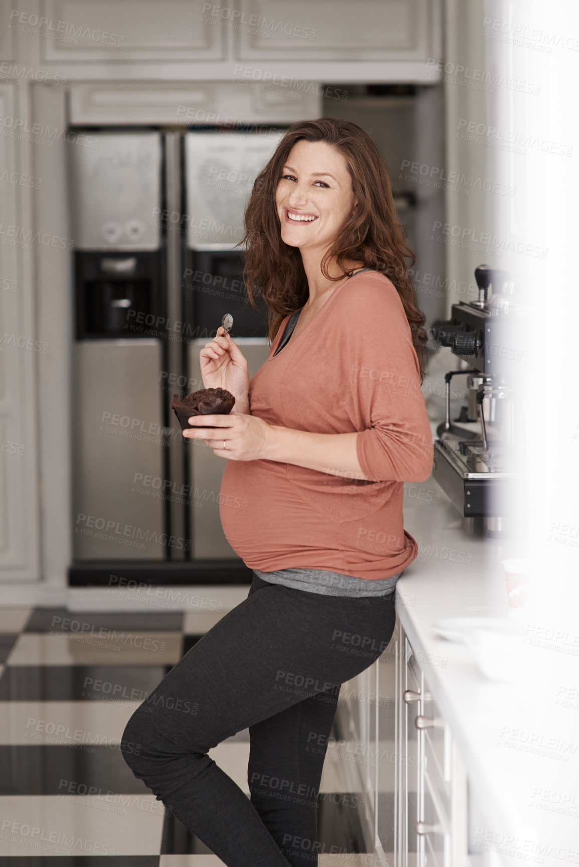 Buy stock photo Woman, pregnancy and snack in home portrait, sweet craving and cupcake for happiness. Female person, morning breakfast and sugar calories in meal for appetite, chocolate dessert and nutrition in diet