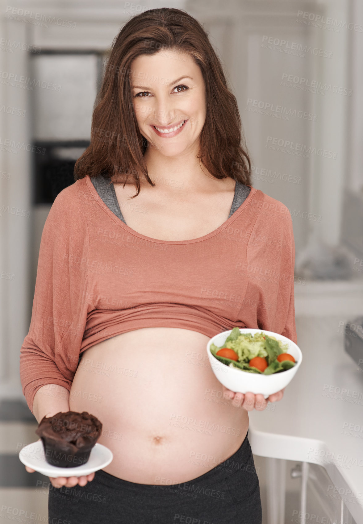 Buy stock photo Pregnant woman, cupcake choice and salad in portrait for nutrition, prenatal diet or maternity. Pregnancy, happy mother and healthy meal decision, vegetable and temptation for unhealthy food in home