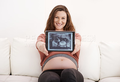 Buy stock photo Portrait of a glowing young pregnant woman showing her ultrasound on a digital tablet