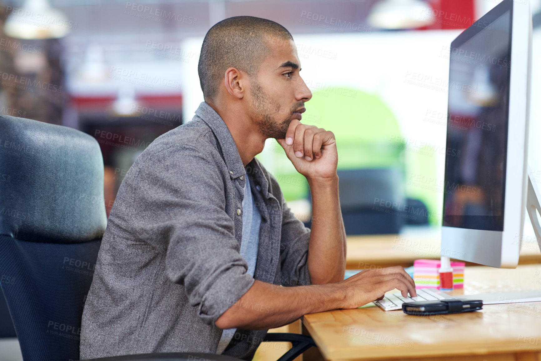 Buy stock photo Shot of a designer at work on a computer in an office