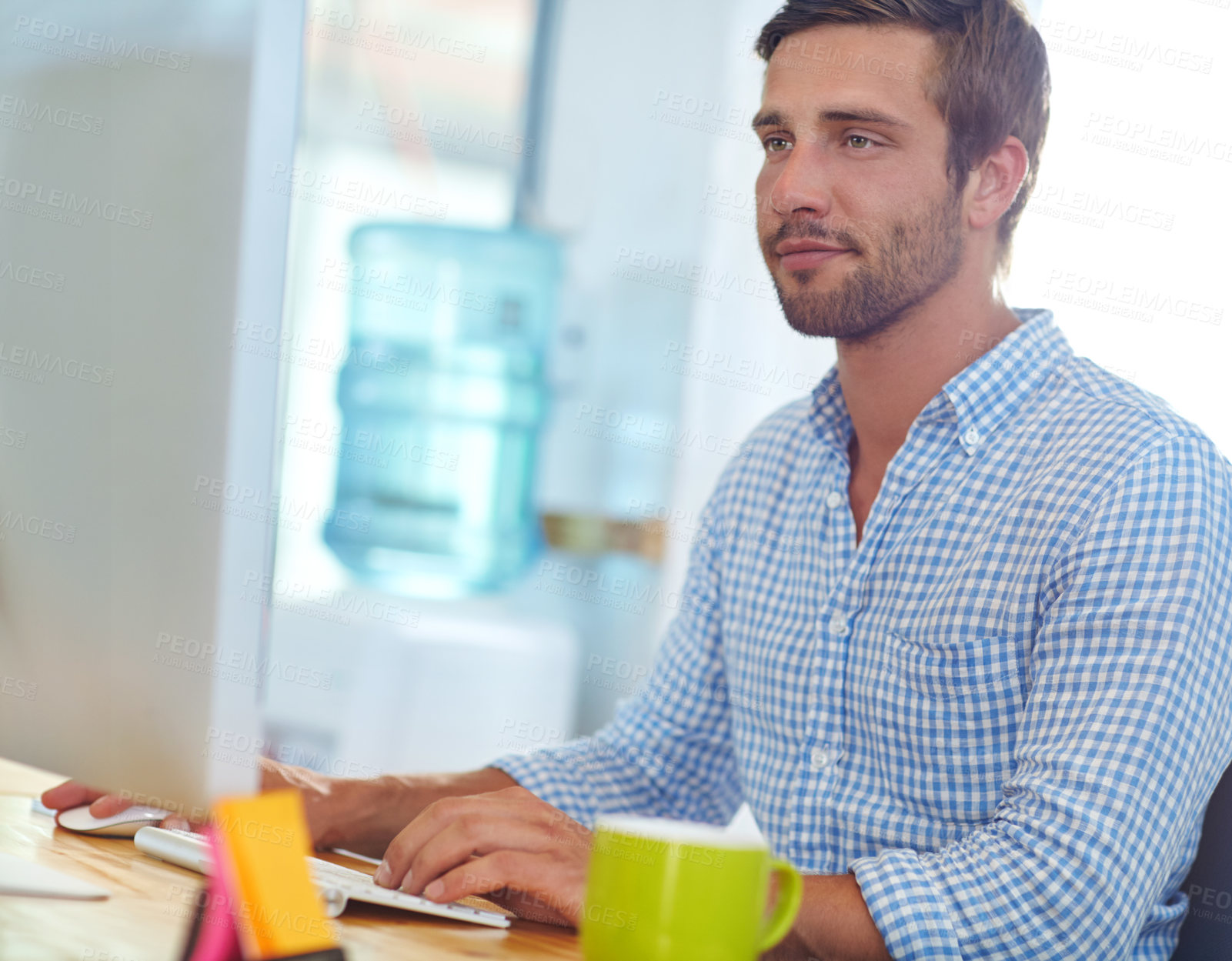 Buy stock photo Shot of a designer at work on a computer in an office