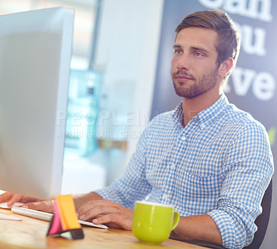 Buy stock photo Shot of a designer at work on a computer in an office