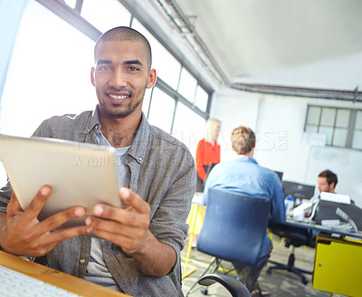 Buy stock photo Portrait of a designer using a digital tablet while working in an office