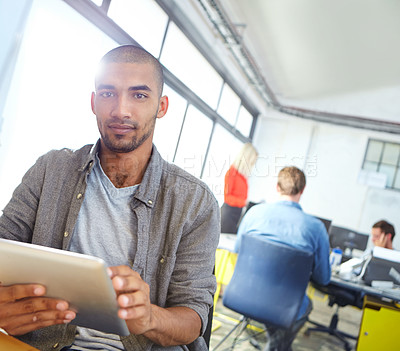 Buy stock photo Portrait of a designer using a digital tablet while working in an office