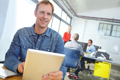 Buy stock photo Portrait of a designer using a digital tablet while working in an office