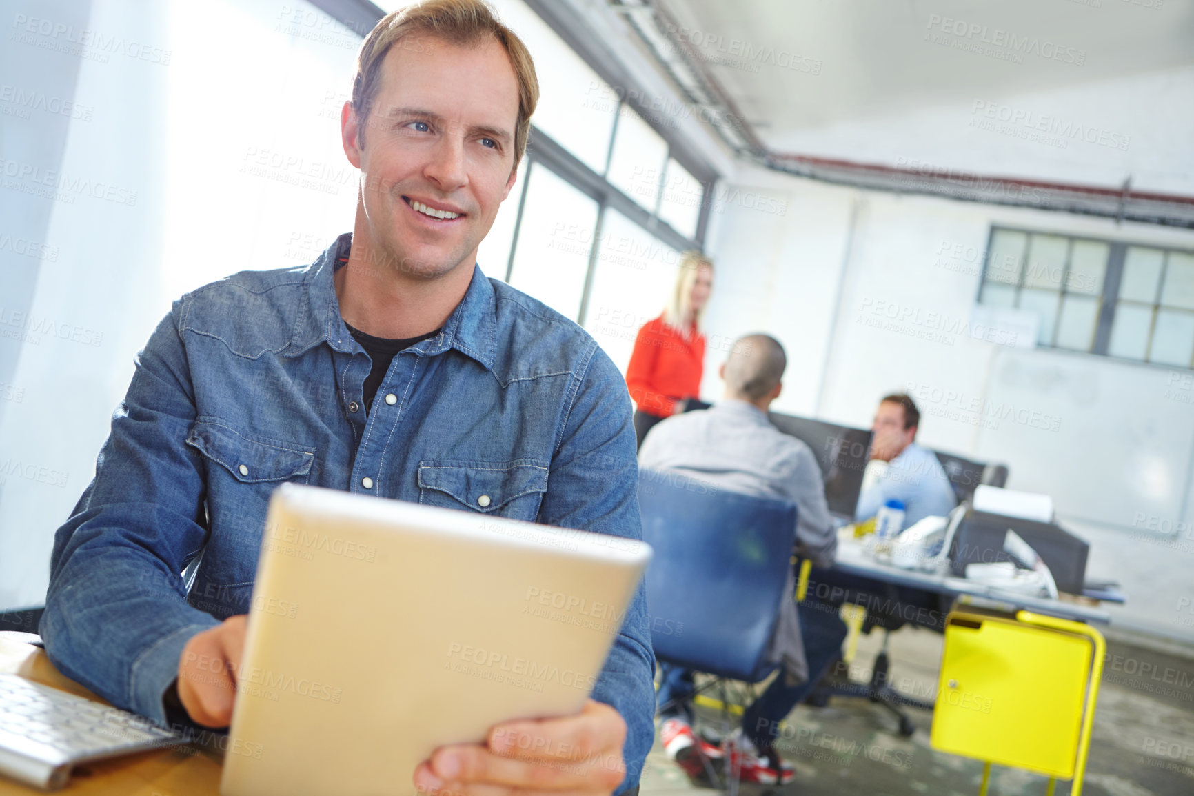 Buy stock photo Portrait of a designer using a digital tablet while working in an office