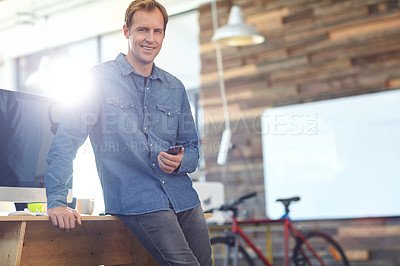Buy stock photo Portrait of  designer using a cellphone while at work in an office