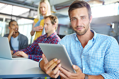 Buy stock photo Portrait of a designer using a digital tablet with colleagues in the background