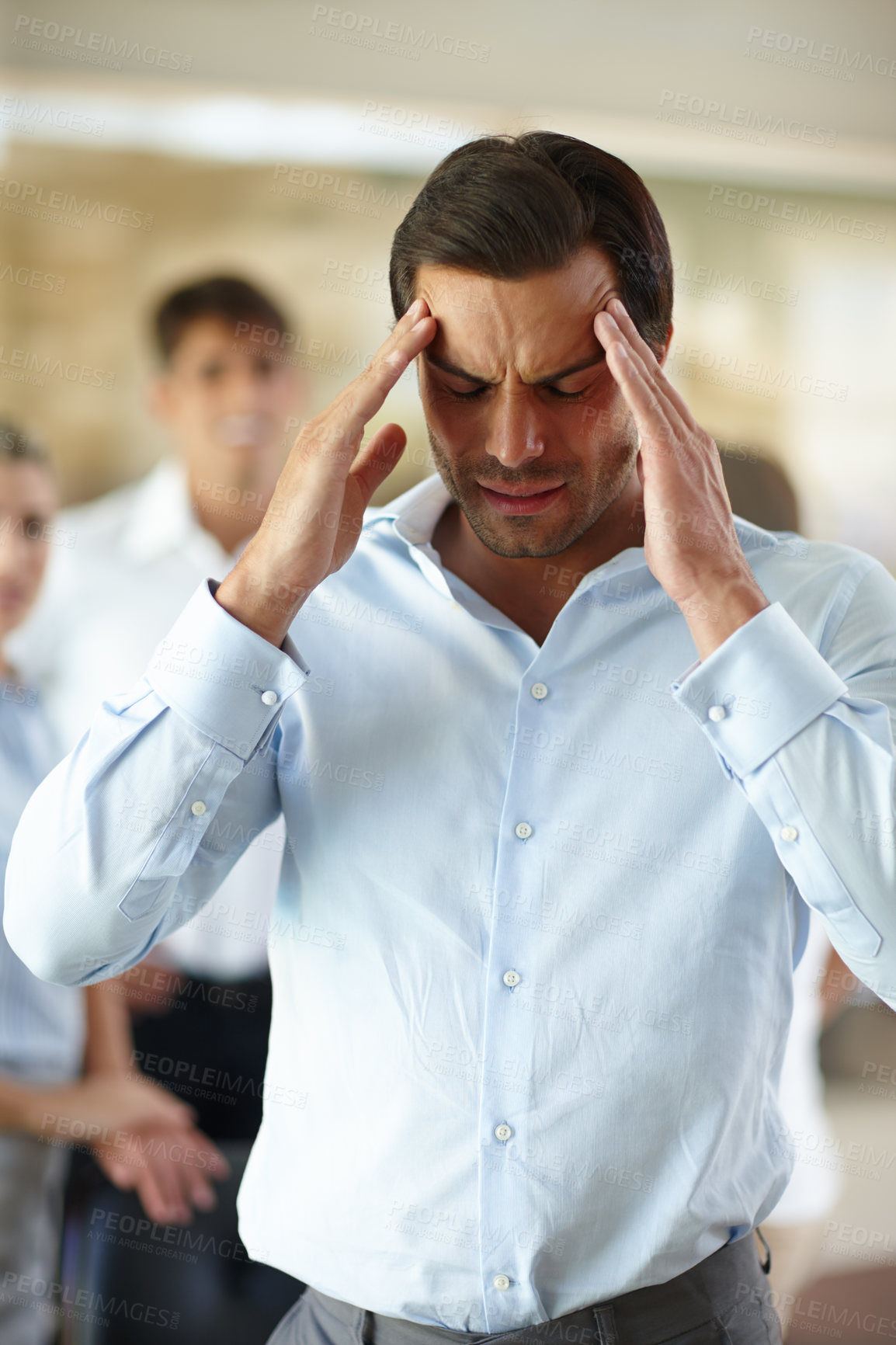 Buy stock photo Shot of a businessman suffering from a headache at the office