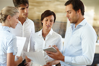 Buy stock photo Shot of a group of business colleagues working together in the office