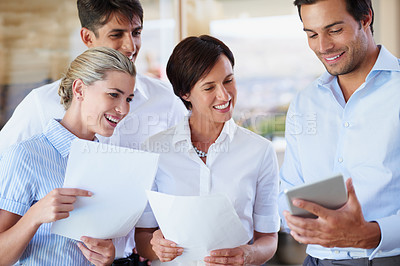 Buy stock photo Shot of a group of business colleagues discussing work during a meeting