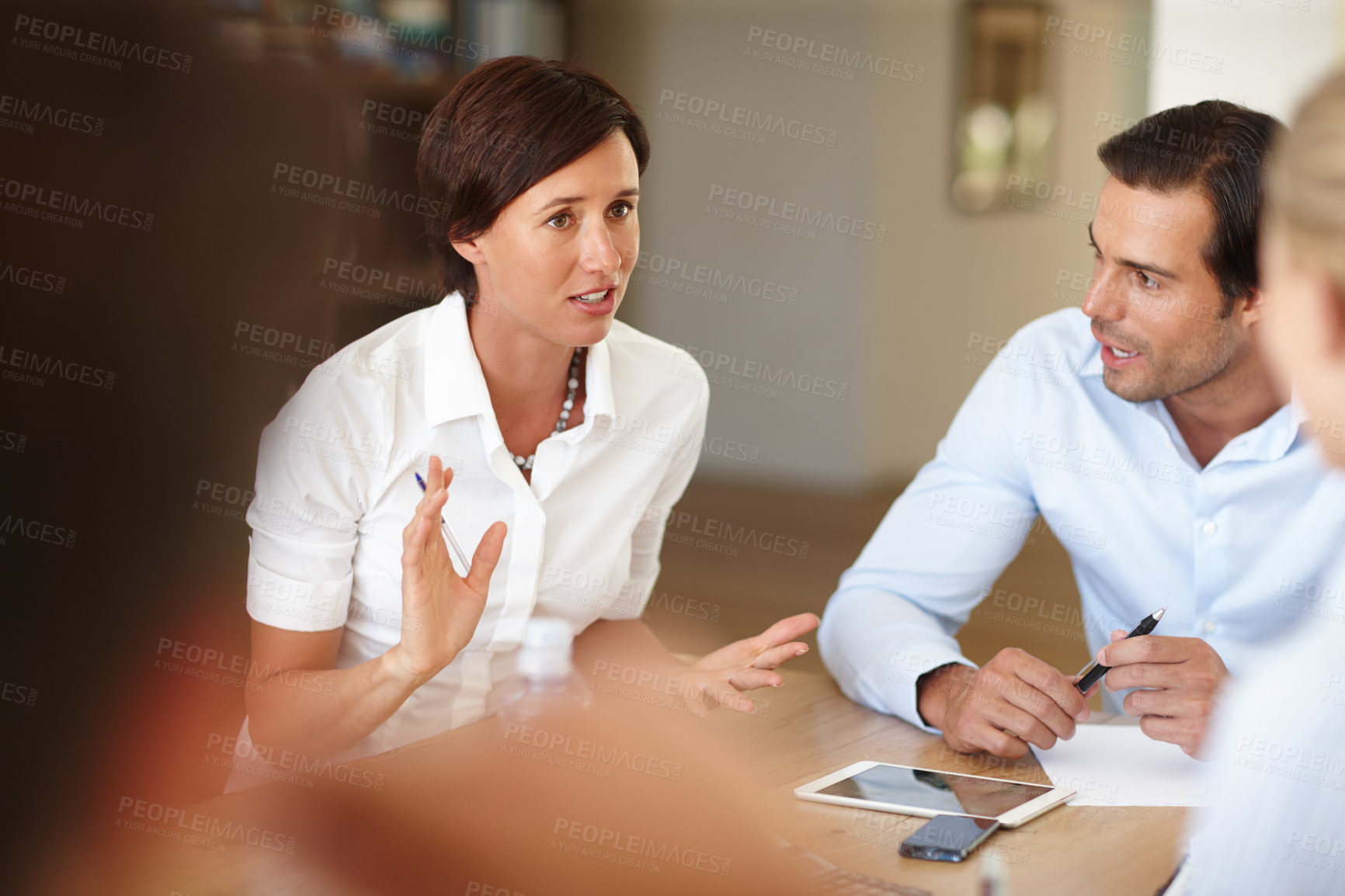 Buy stock photo Shot of a group of colleagues discussing work during a meeting