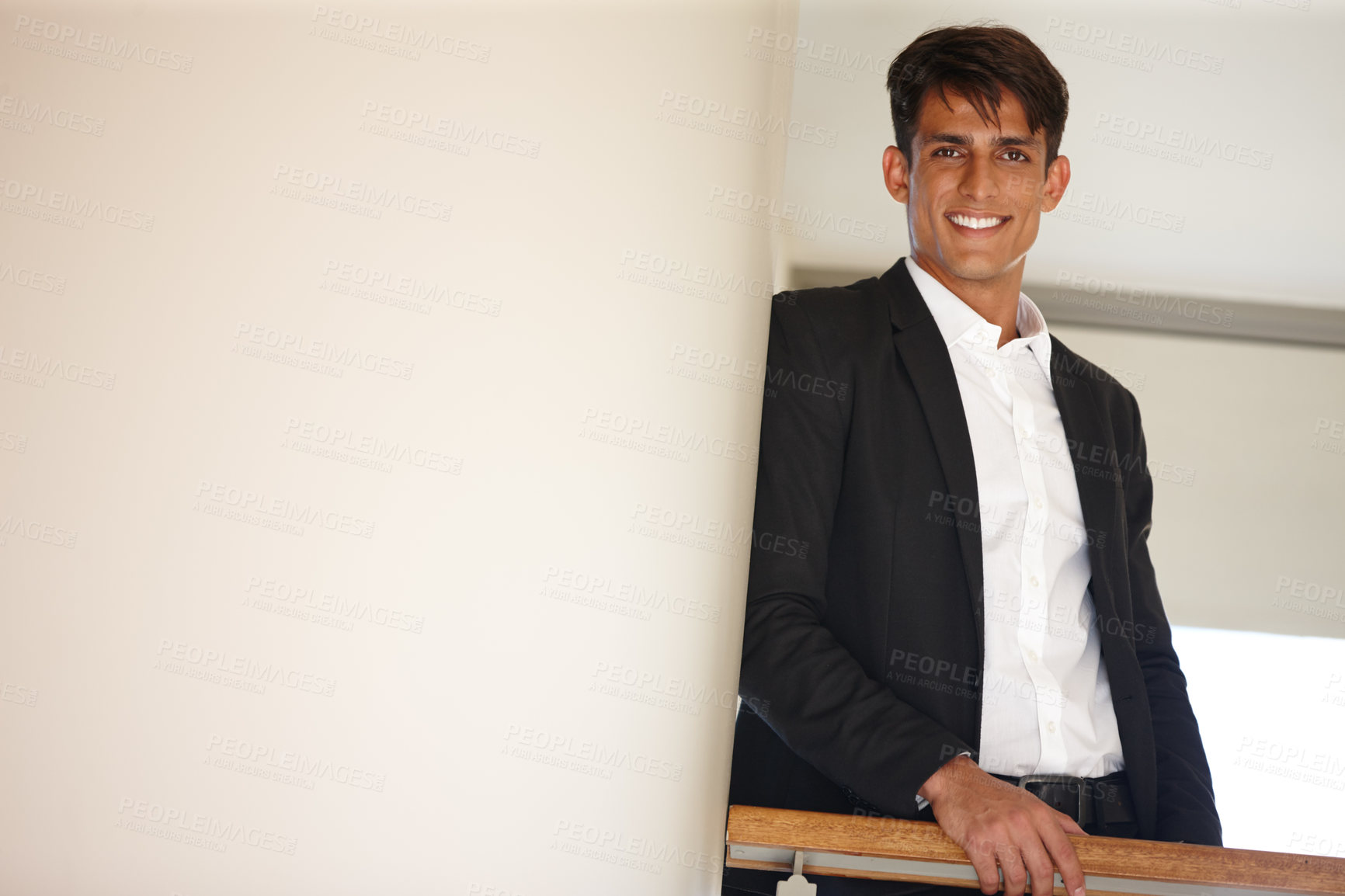 Buy stock photo Portrait of a handsome young businessman standing confidently indoors